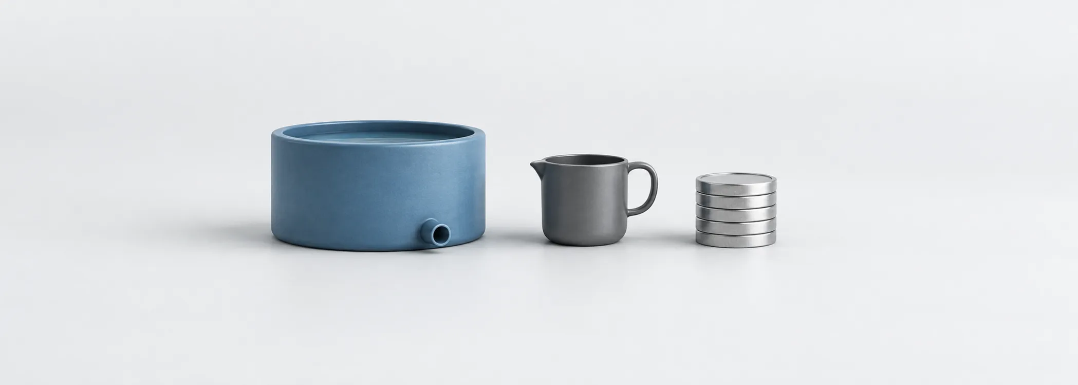 A steel-blue reservoir, graphite measuring cup and silver coins represent measuring the cash supporting a dividend.