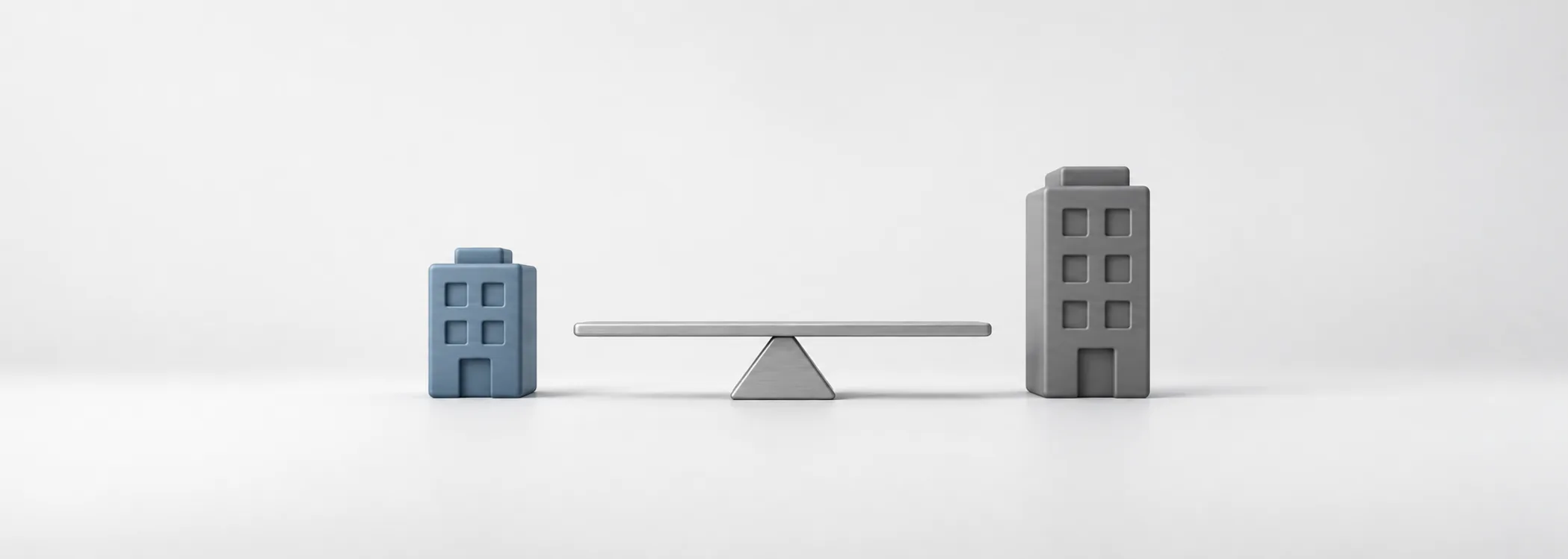 A small steel-blue building, a tall graphite building and a silver balance beam represent comparing company sizes.